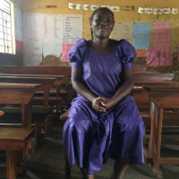 Senior woman teacher madam Winfred Biira giving her remarks